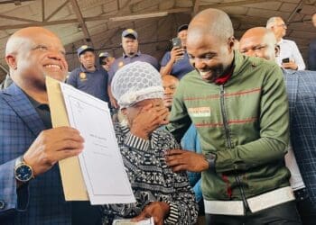 City of Johannesburg Executive Mayor Dada Morero and MMC Mlungisi Mabaso share a heartfelt moment with beneficiary TL Maisela, who is overcome with emotion while receiving her title deed (Image: Viki Stuurman)