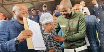 City of Johannesburg Executive Mayor Dada Morero and MMC Mlungisi Mabaso share a heartfelt moment with beneficiary TL Maisela, who is overcome with emotion while receiving her title deed (Image: Viki Stuurman)