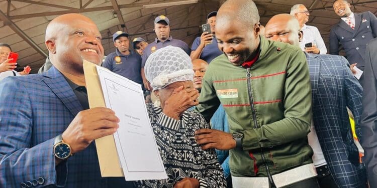 City of Johannesburg Executive Mayor Dada Morero and MMC Mlungisi Mabaso share a heartfelt moment with beneficiary TL Maisela, who is overcome with emotion while receiving her title deed (Image: Viki Stuurman)